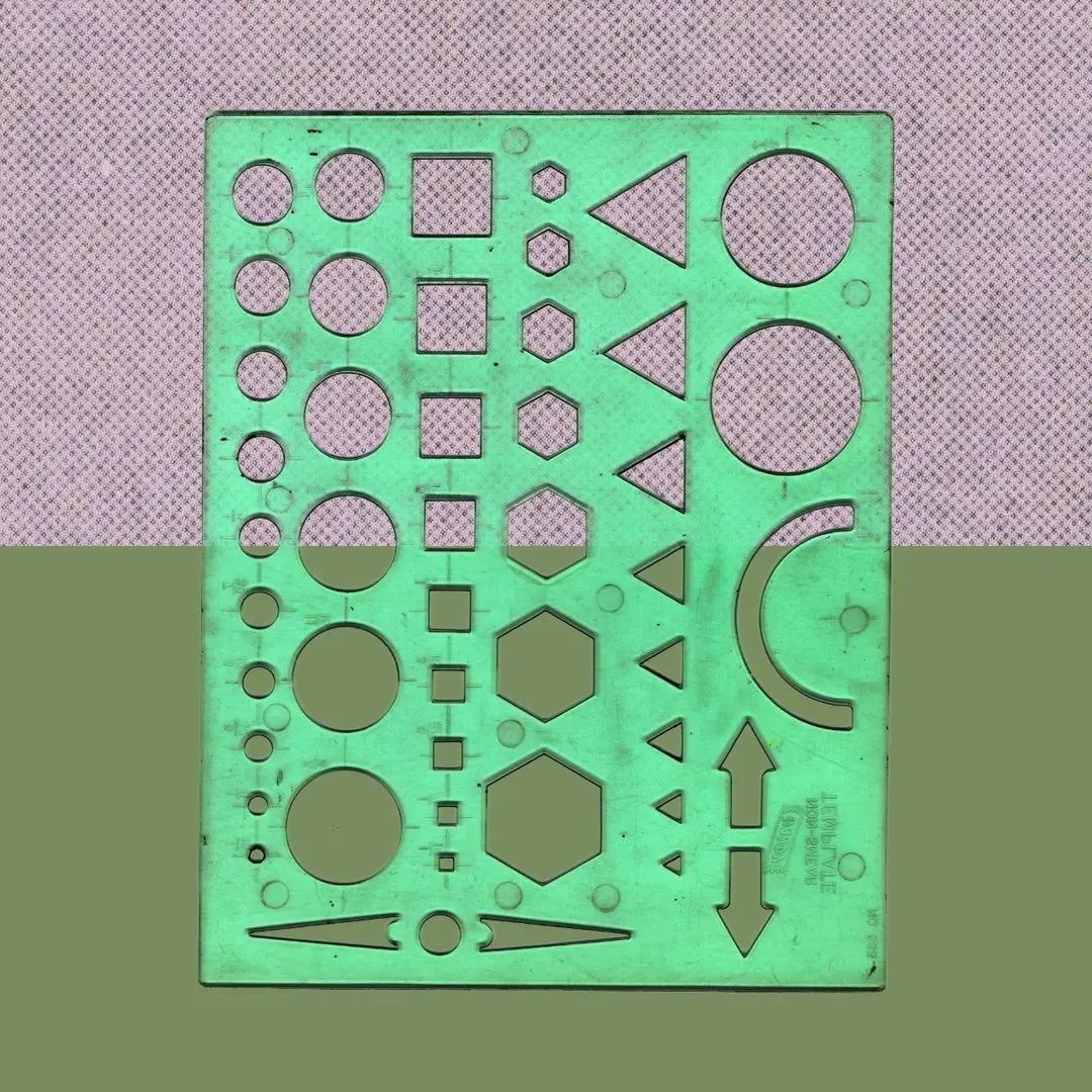 Green drafting stencil of cut-out shapes on a coral background.